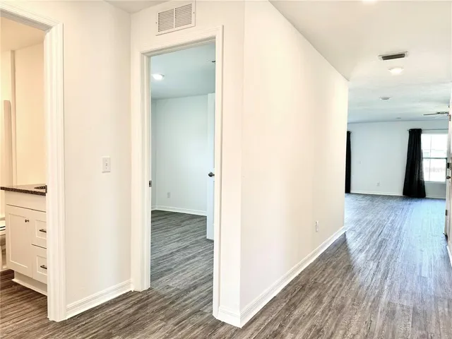 a kitchen with stainless steel appliances kitchen island granite countertop a stove a refrigerator and a microwave