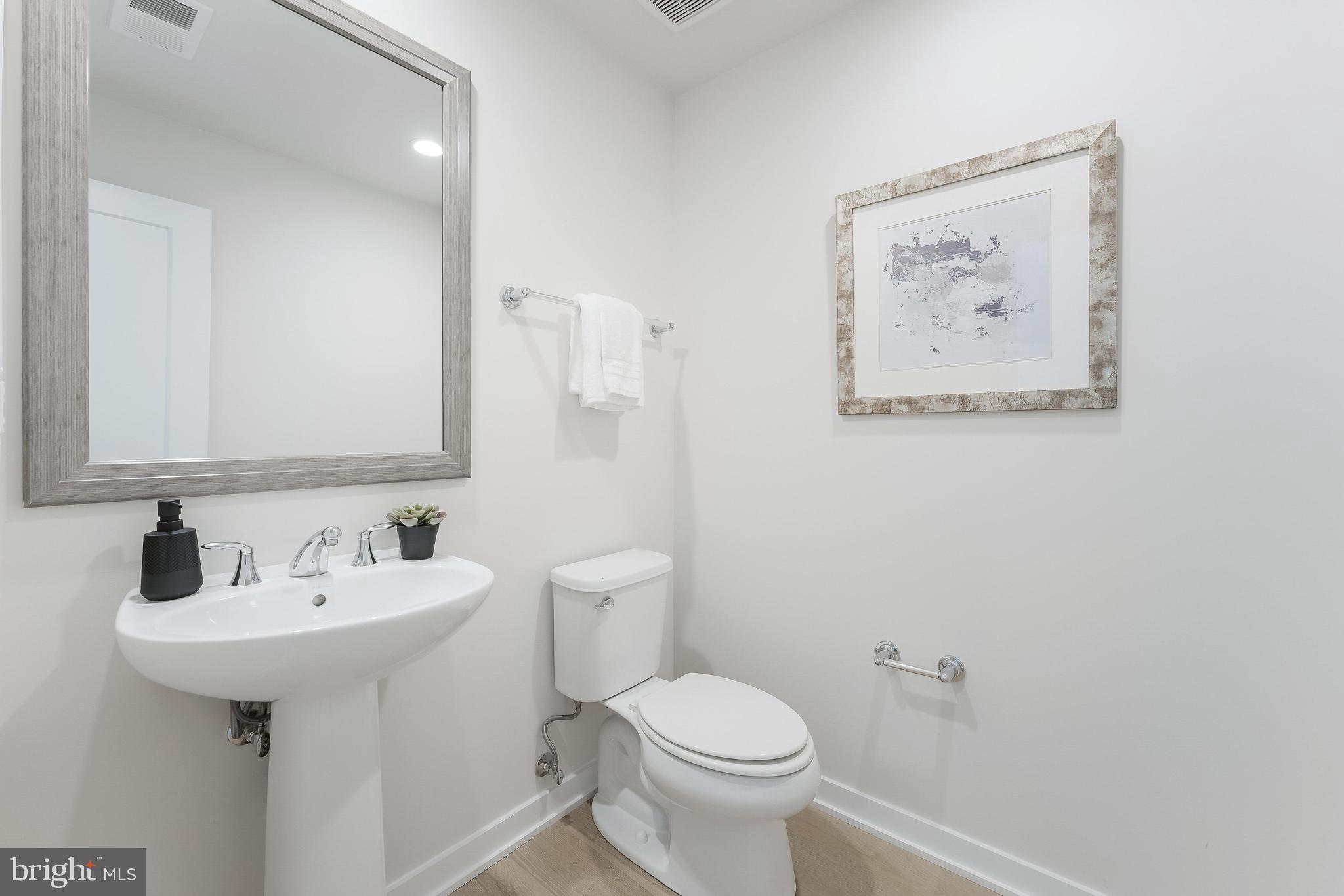 11748 Sunrise Valley Drive Reston, VA 20191 - Photo 12 of 60 a bathroom with a toilet sink and mirror