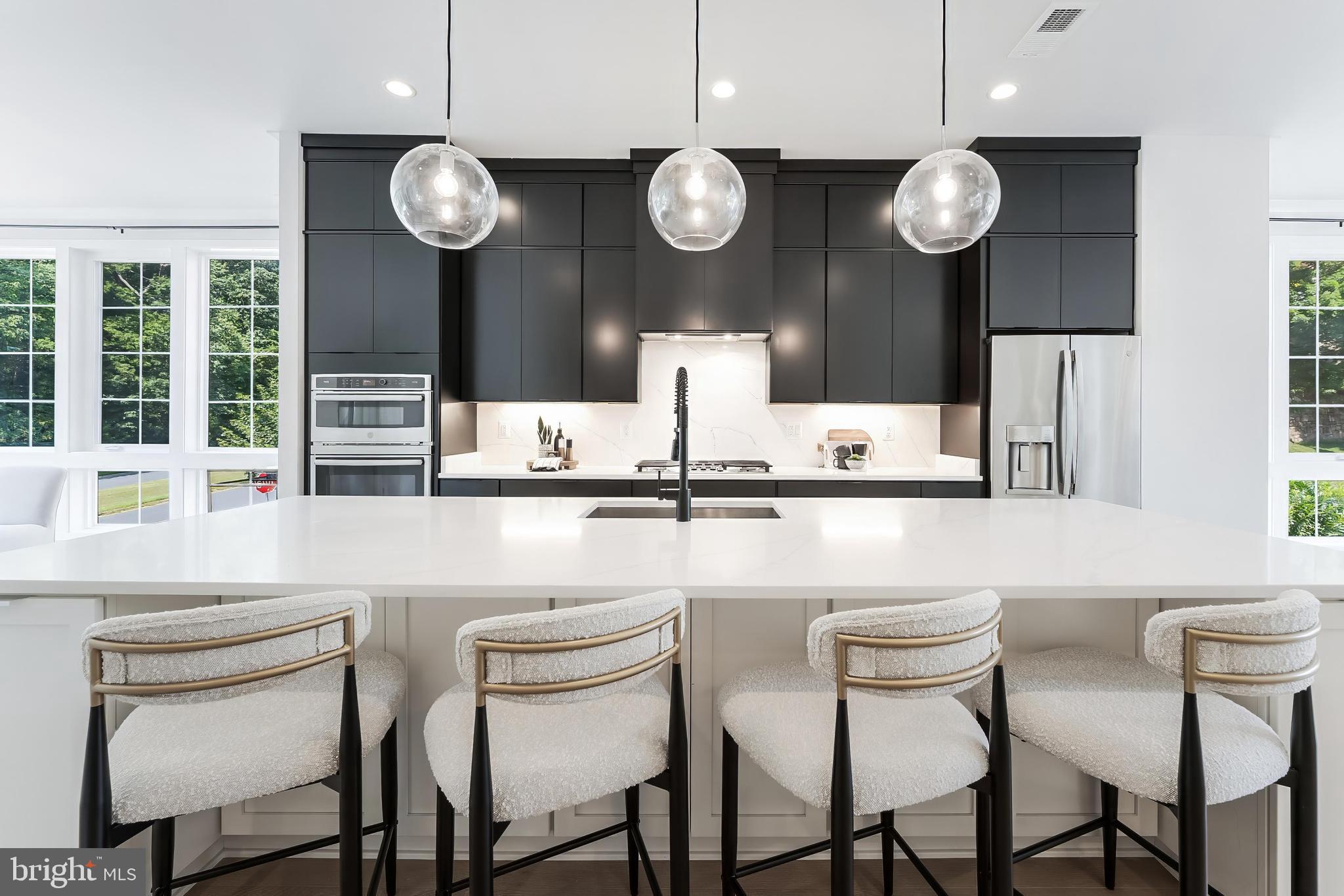 11748 Sunrise Valley Drive Reston, VA 20191 - Photo 20 of 60 a kitchen with a dining table and chairs
