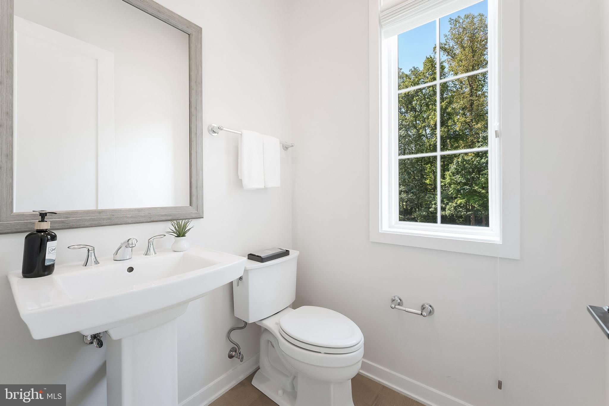 11748 Sunrise Valley Drive Reston, VA 20191 - Photo 26 of 60 a bathroom with a sink a toilet and a mirror
