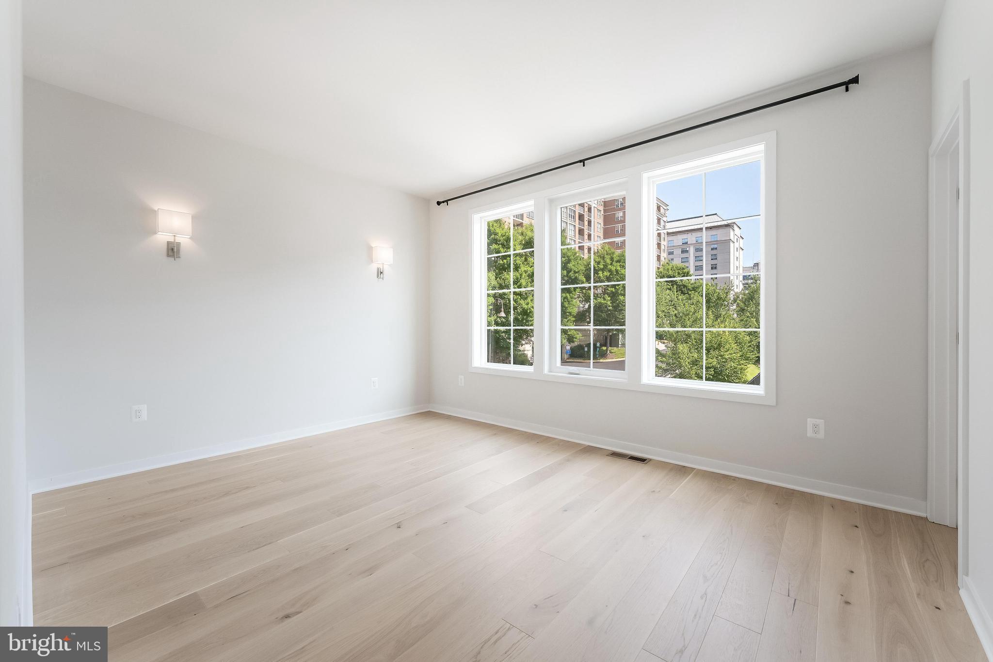11748 Sunrise Valley Drive Reston, VA 20191 - Photo 30 of 60 an empty room with wooden floor and windows