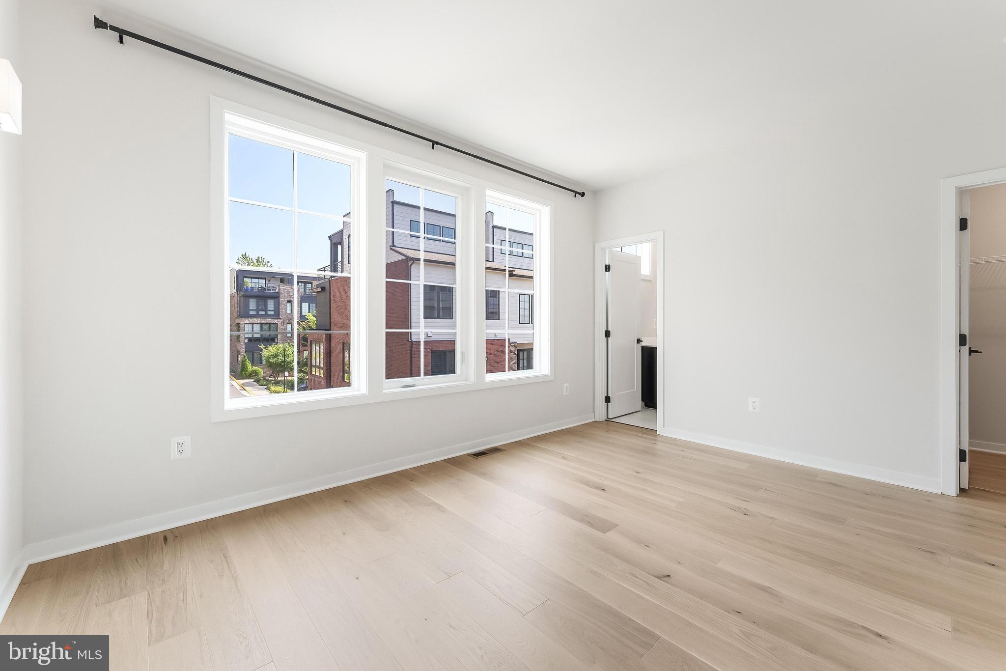 11748 Sunrise Valley Drive Reston, VA 20191 - Photo 33 of 60 an empty room with wooden floor and windows
