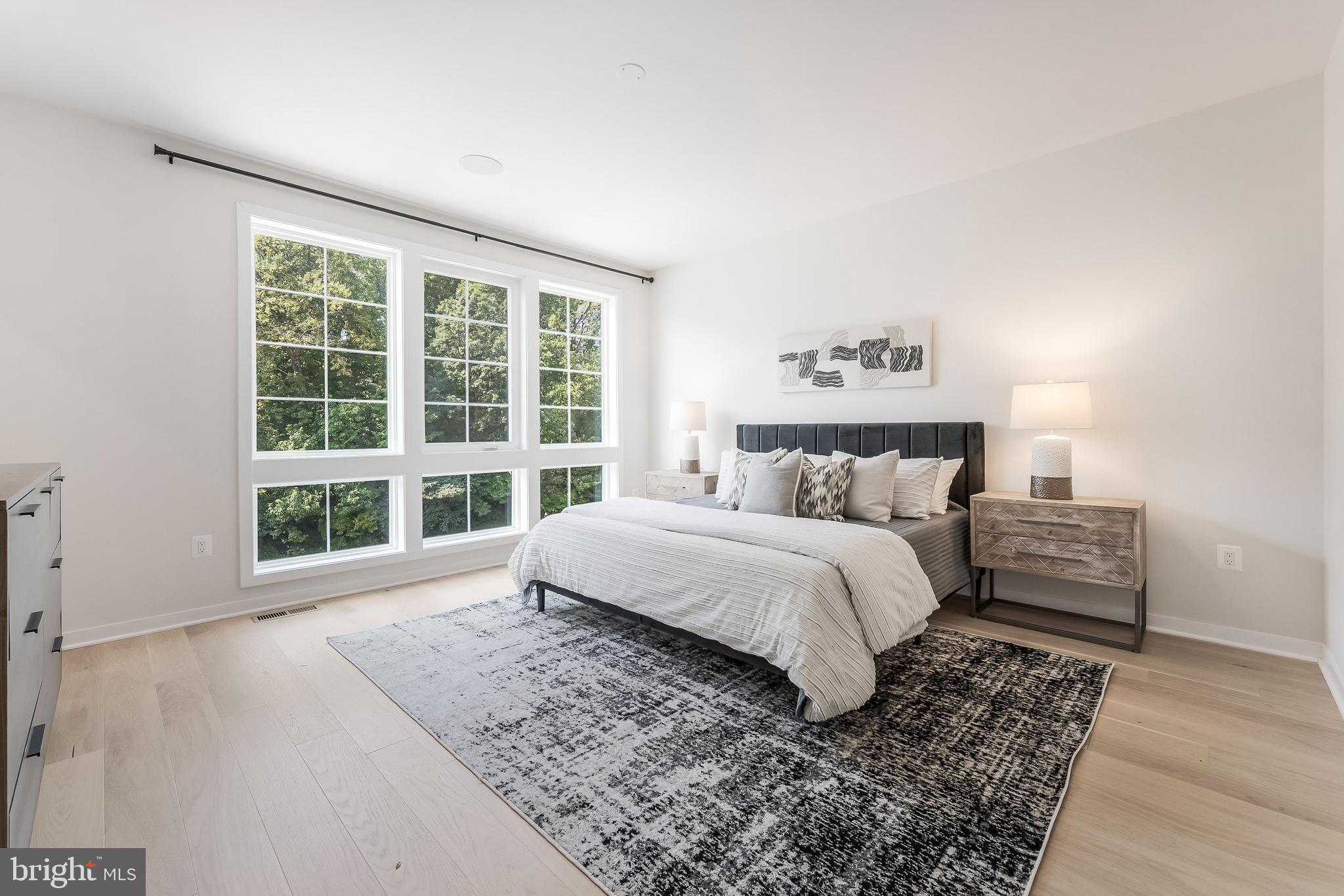 11748 Sunrise Valley Drive Reston, VA 20191 - Photo 36 of 60 a large bed sitting in a bedroom next to a window