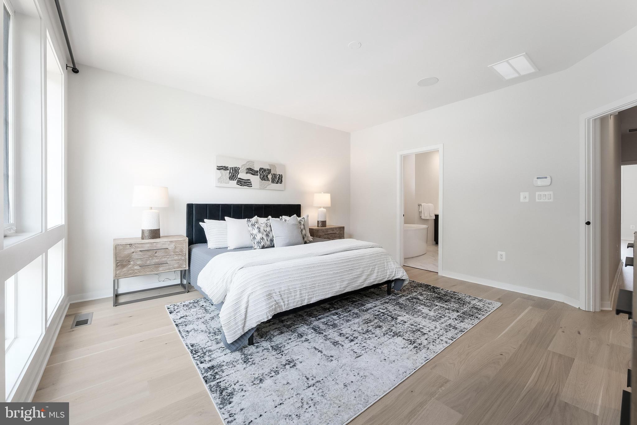 11748 Sunrise Valley Drive Reston, VA 20191 - Photo 37 of 60 a spacious bedroom with a bed and a window