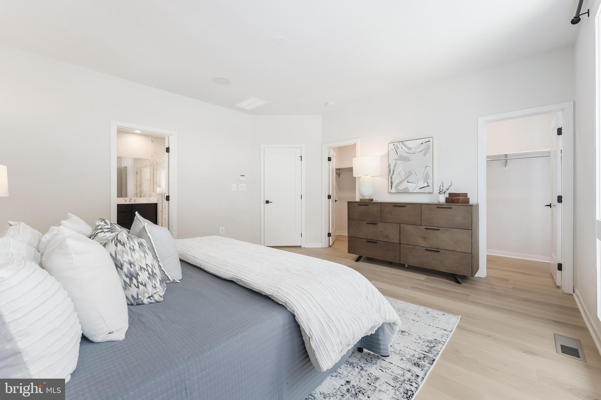 11748 Sunrise Valley Drive Reston, VA 20191 - Photo 38 of 60 a bedroom with a bed and a mirror