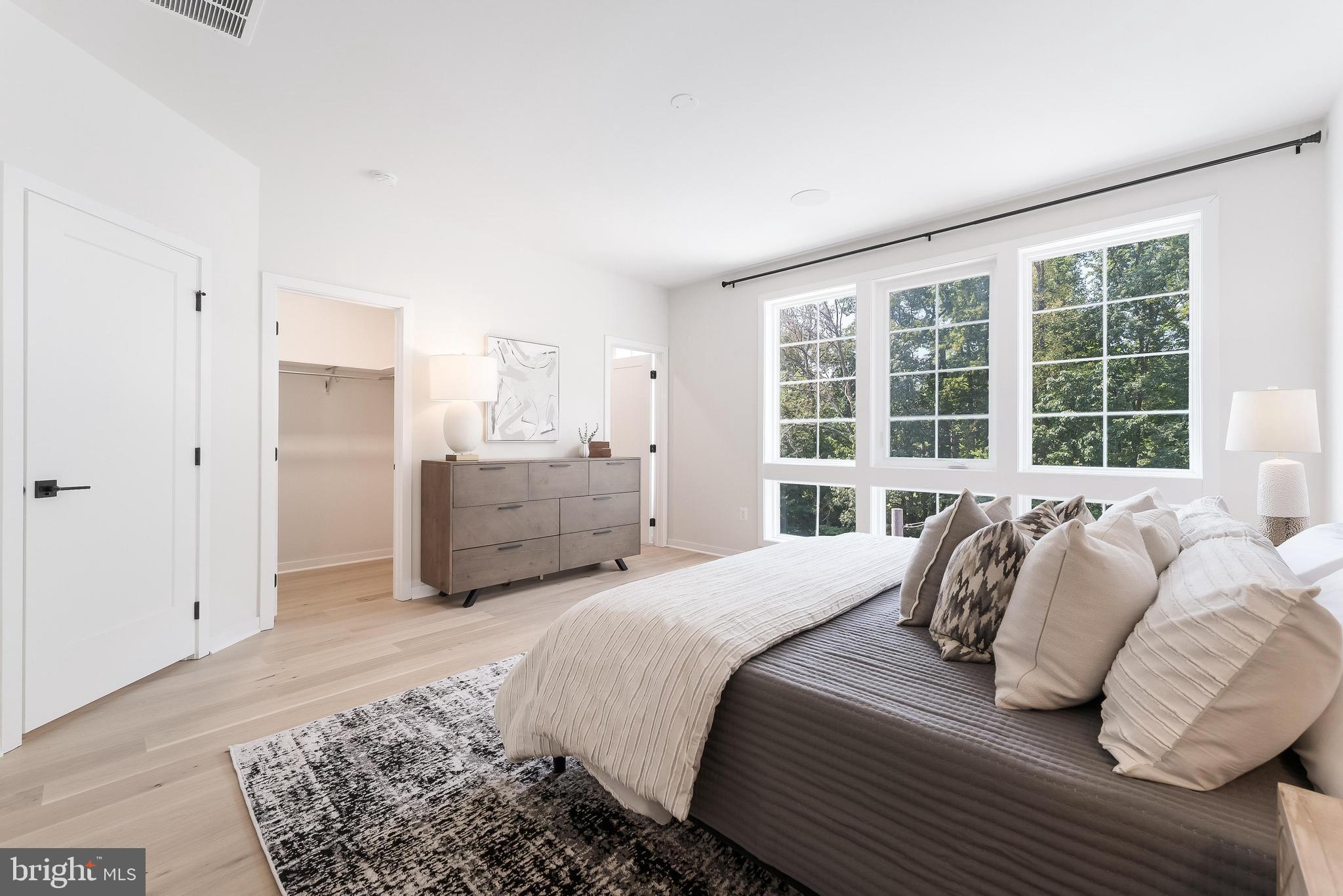 11748 Sunrise Valley Drive Reston, VA 20191 - Photo 39 of 60 a bedroom with a bed and a large window