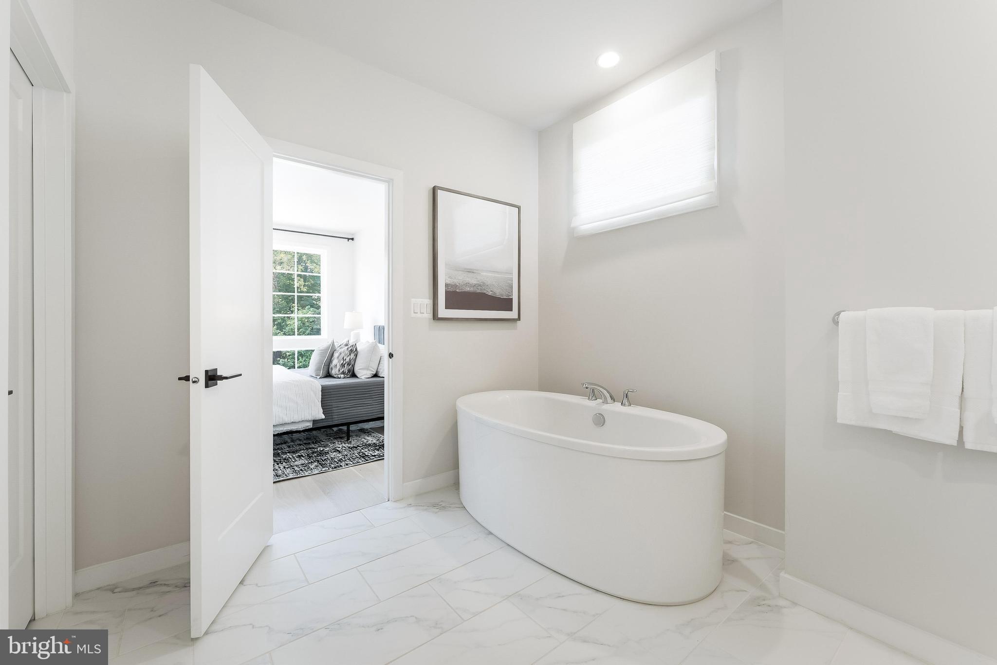 11748 Sunrise Valley Drive Reston, VA 20191 - Photo 43 of 60 a bathroom with a sink toilet and shower