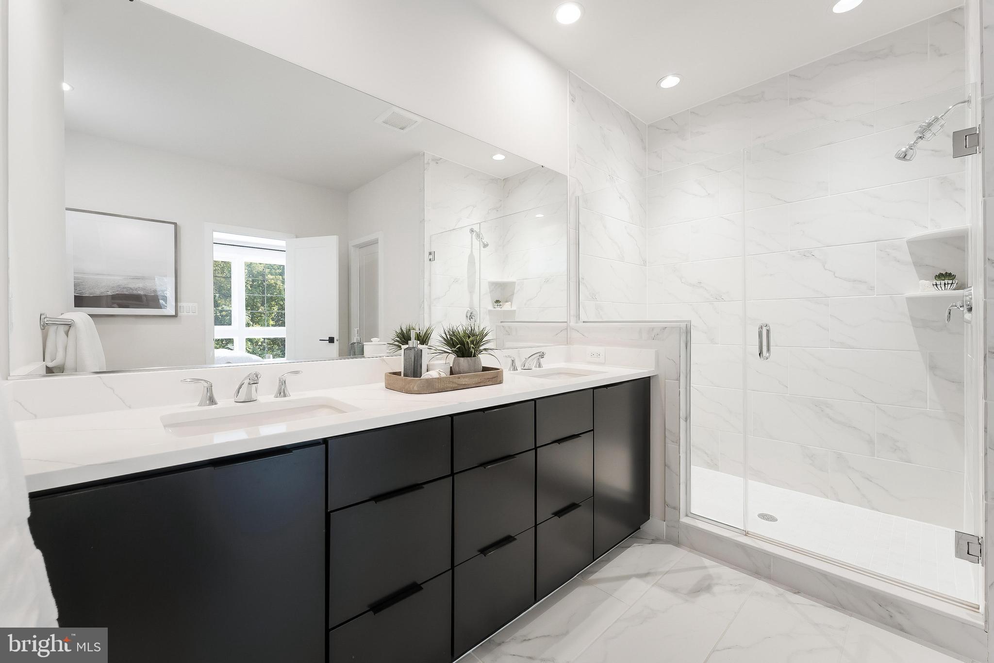11748 Sunrise Valley Drive Reston, VA 20191 - Photo 44 of 60 a bathroom with a sink double vanity and a mirror