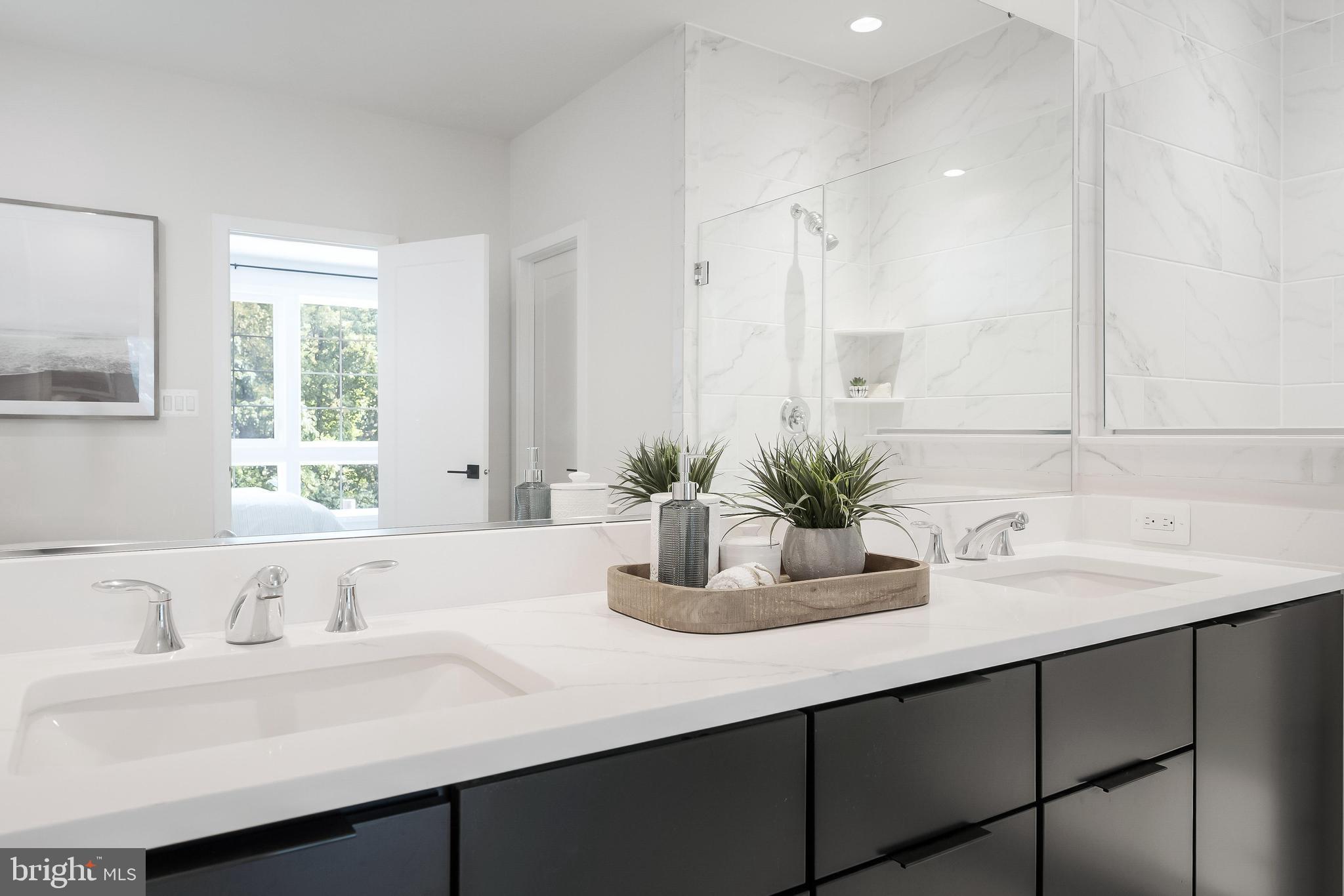 11748 Sunrise Valley Drive Reston, VA 20191 - Photo 45 of 60 a bathroom with a sink a mirror and a window