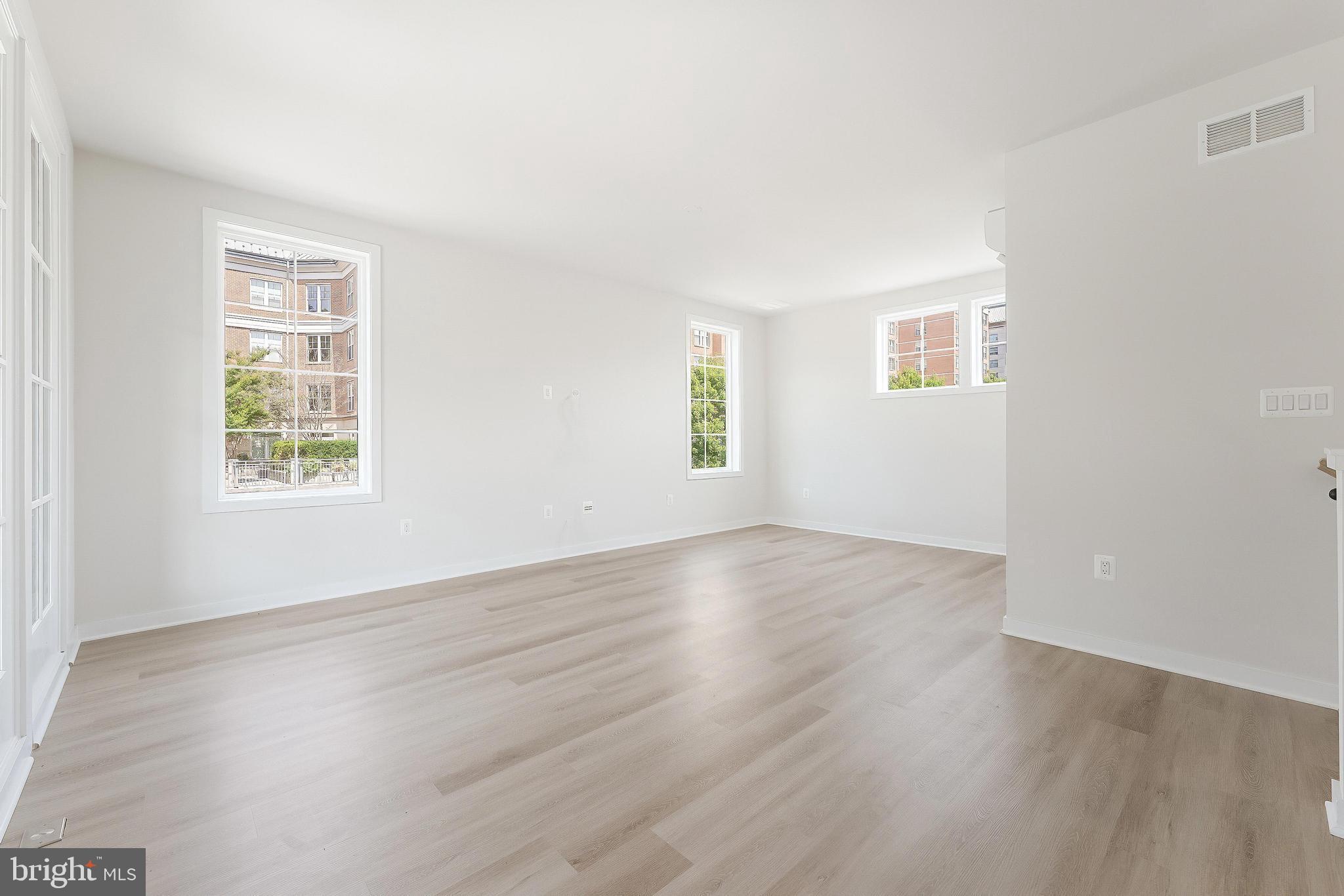 11748 Sunrise Valley Drive Reston, VA 20191 - Photo 47 of 60 an empty room with wooden floor and windows