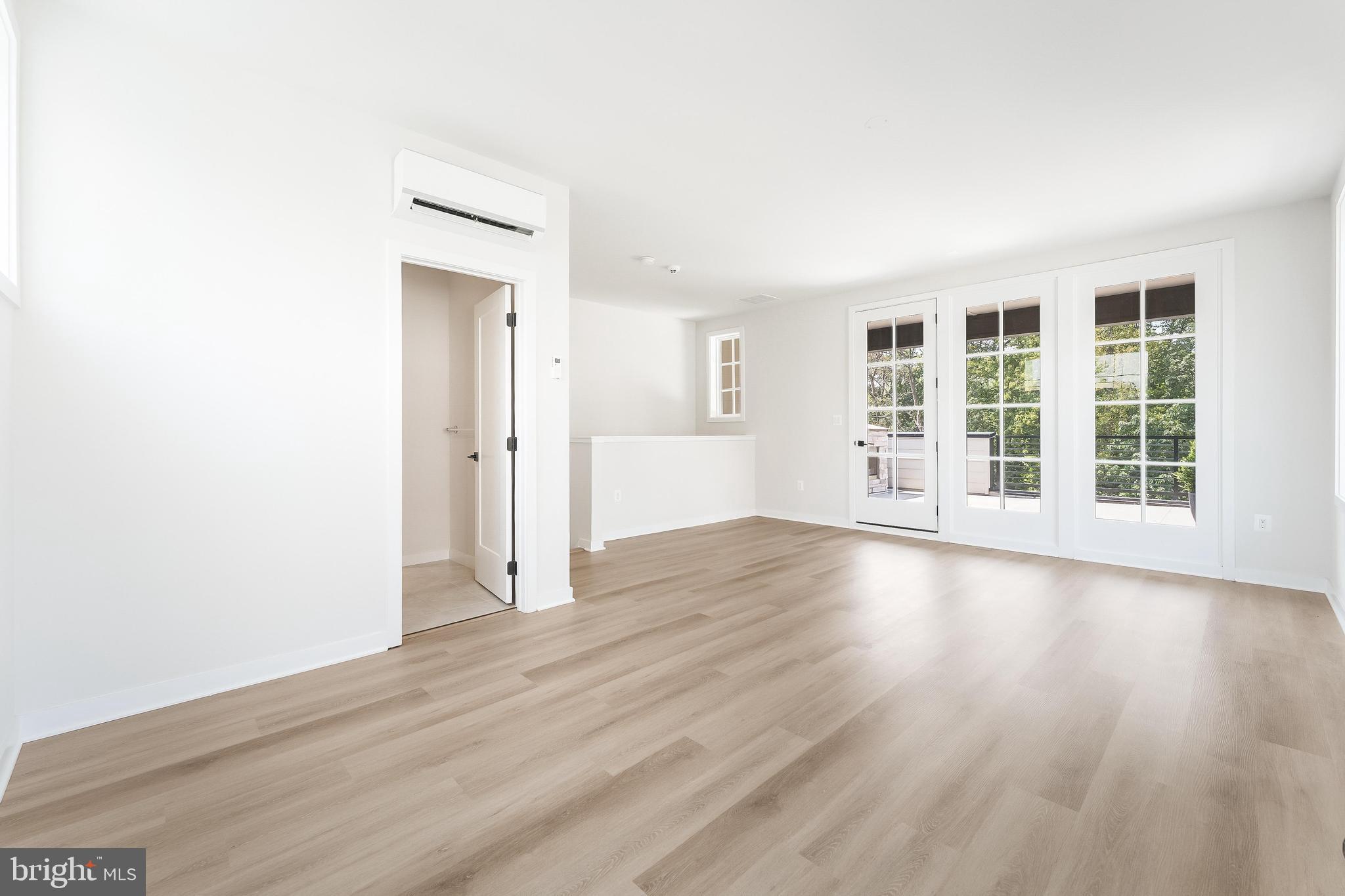 11748 Sunrise Valley Drive Reston, VA 20191 - Photo 48 of 60 an empty room with wooden floor and windows