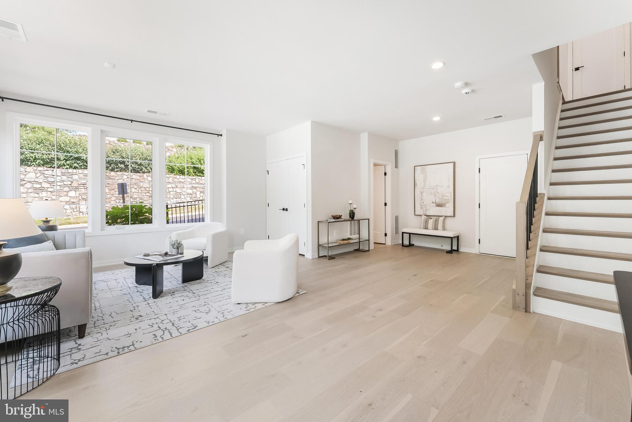 11748 Sunrise Valley Drive Reston, VA 20191 - Photo 5 of 60 a living room with furniture and large windows