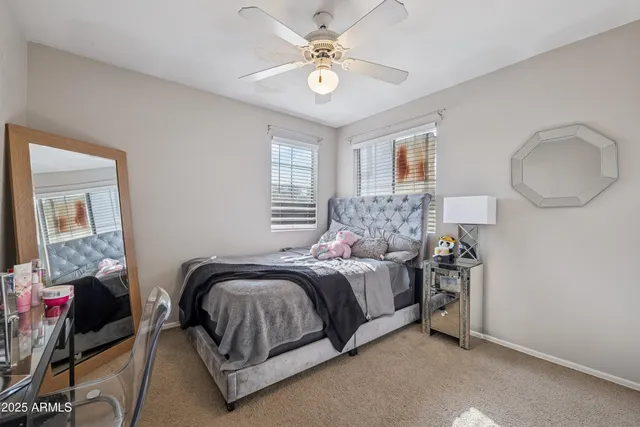 a bedroom with a bed rug and couch