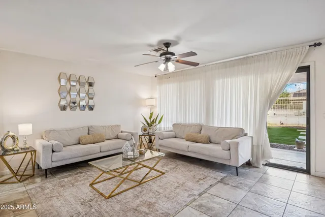 a living room with furniture and a large window