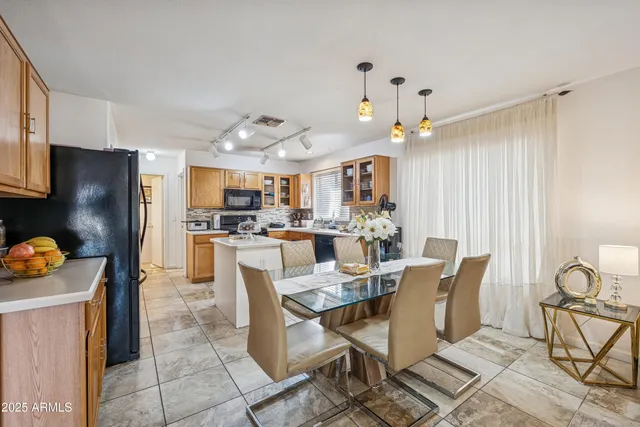 a large kitchen with a table and chairs