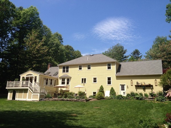 259 Green Road Bolton, MA 01740 - Photo 23 of 24 a view of a white house with a big yard