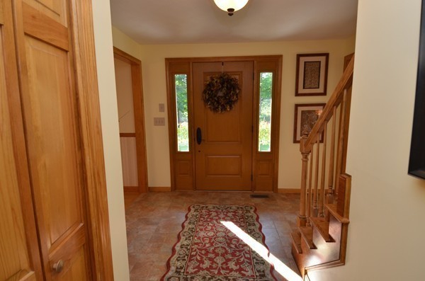 259 Green Road Bolton, MA 01740 - Photo 5 of 24 a view of a hallway with wooden floor and a livingroom to a window