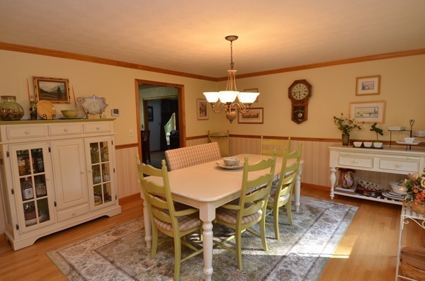 259 Green Road Bolton, MA 01740 - Photo 8 of 24 a living room with a table or chairs and a wooden floor