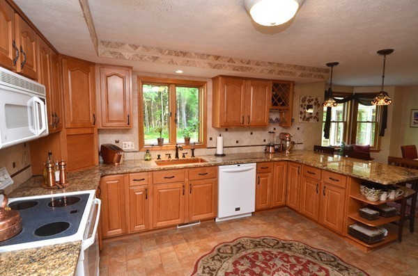 259 Green Road Bolton, MA 01740 - Photo 10 of 24 a kitchen with stainless steel appliances granite countertop a sink a stove and a wooden floors