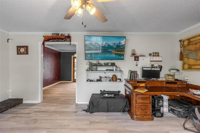 a room with furniture a flat screen tv and a window