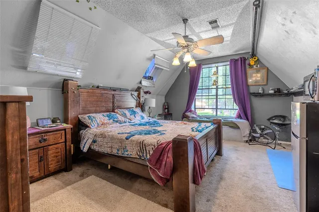 a bedroom with a bed dresser and a window