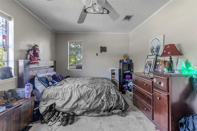 a bedroom with bed and a chandelier