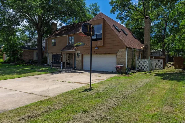 a house that has a tree in front of it