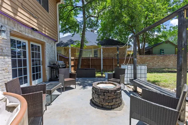 a view of a patio with table and chairs and potted plants