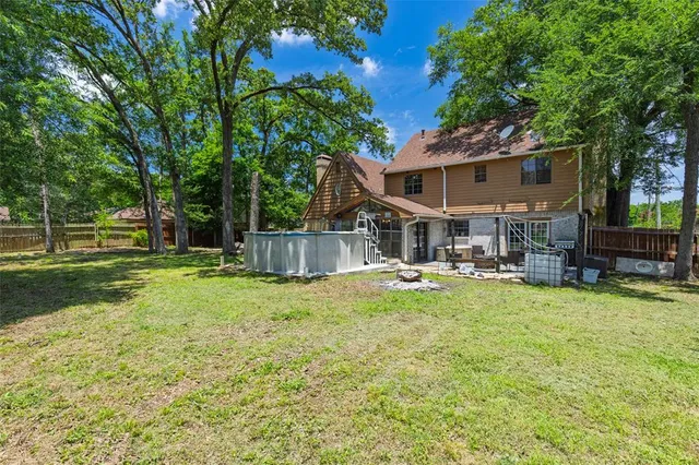 a view of a house with swimming pool and sitting area