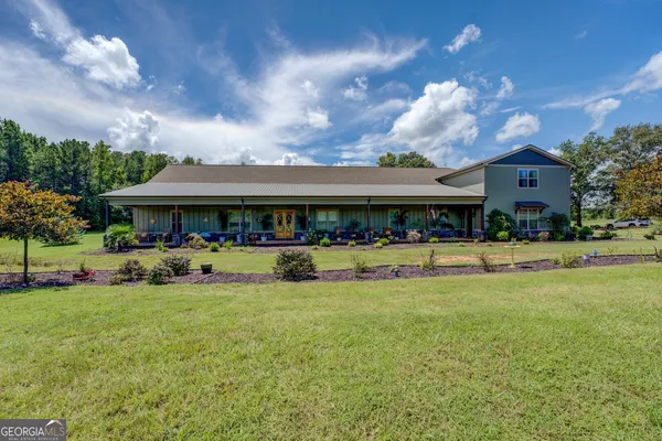 a front view of a house with a yard balcony