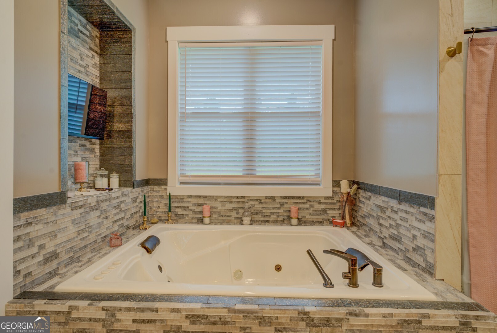 70 McDonald Road Covington, GA 30014 - Photo 37 of 84 a bathroom with a bathtub and a window