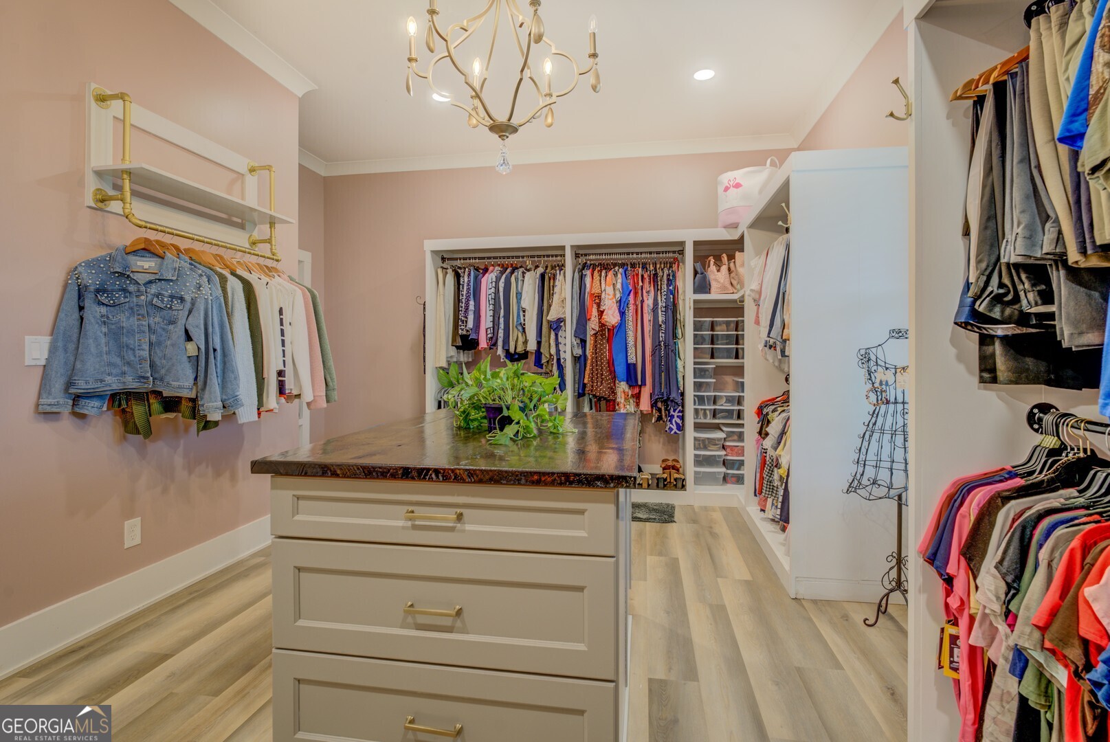 70 McDonald Road Covington, GA 30014 - Photo 40 of 84 a view of walk in closet with clothes and shoes