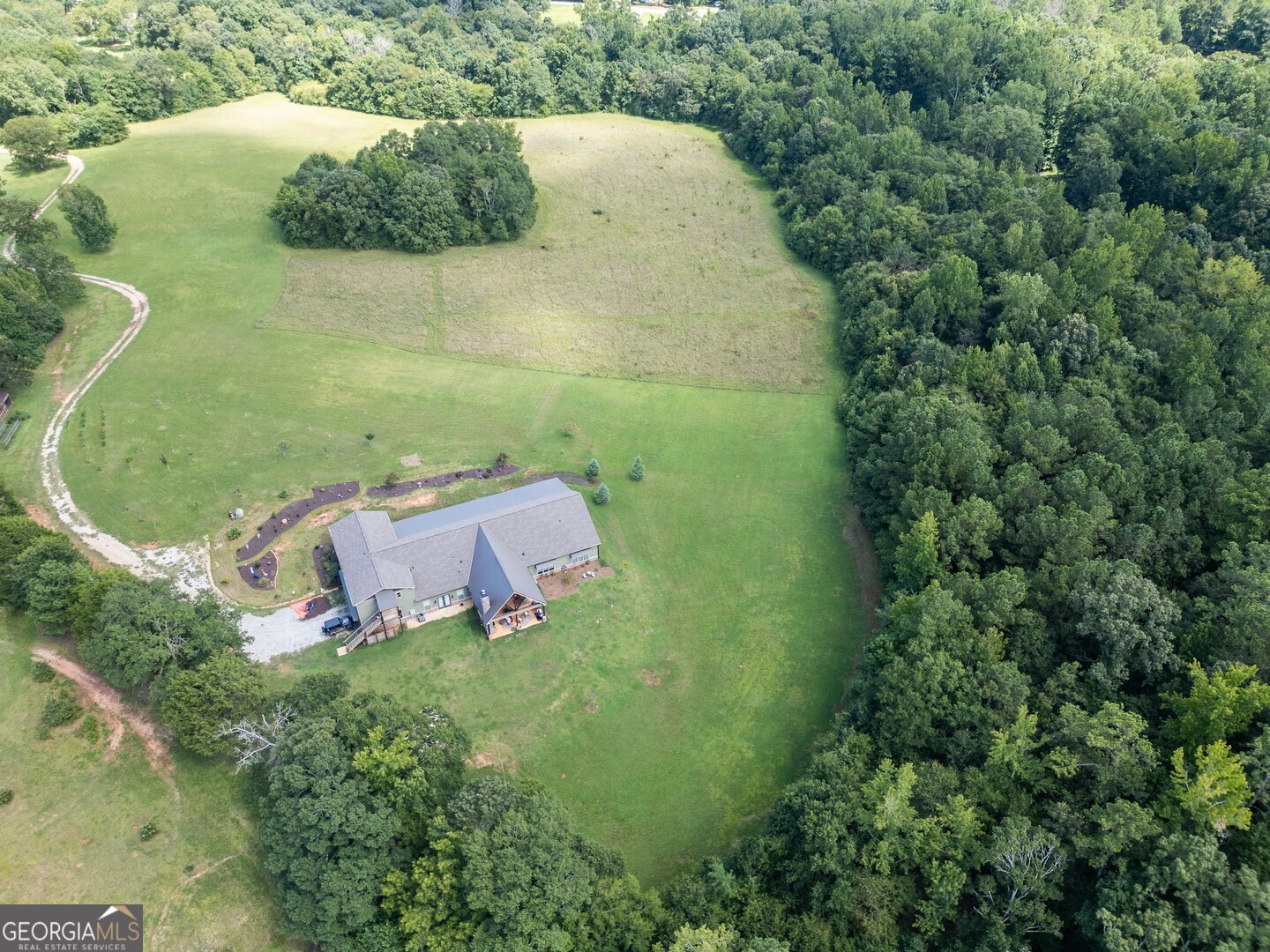 70 McDonald Road Covington, GA 30014 - Photo 4 of 84 an aerial view of a house with a yard and trees