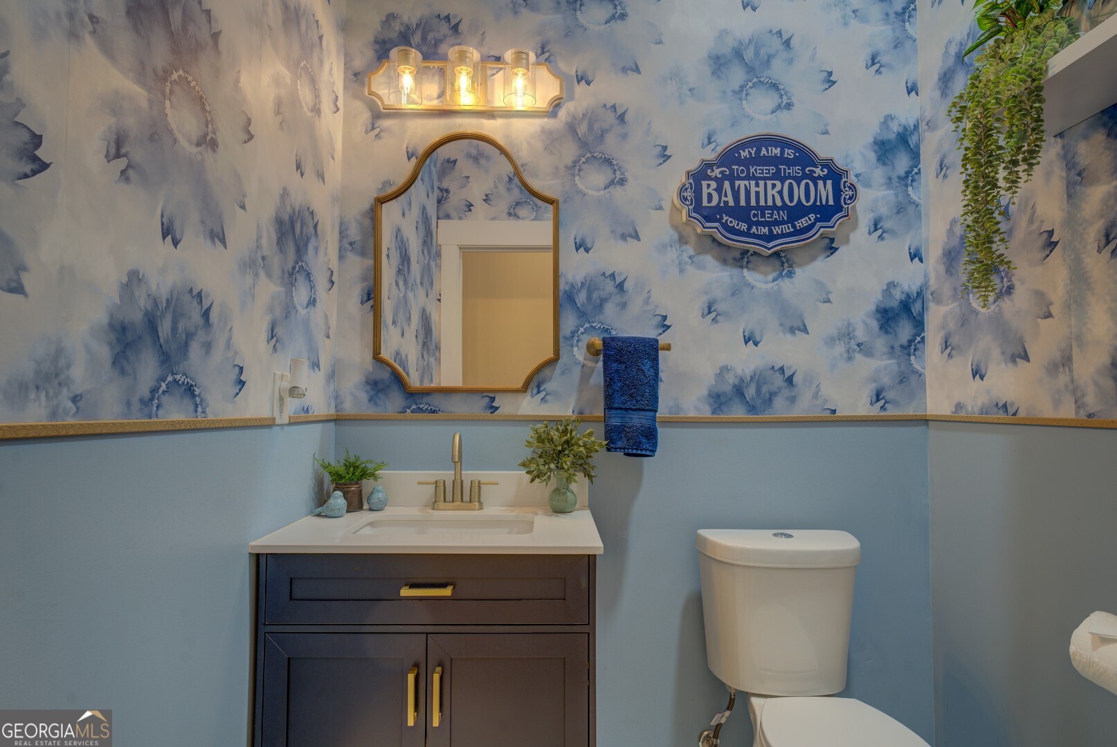 70 McDonald Road Covington, GA 30014 - Photo 44 of 84 a bathroom with a toilet a sink and a mirror