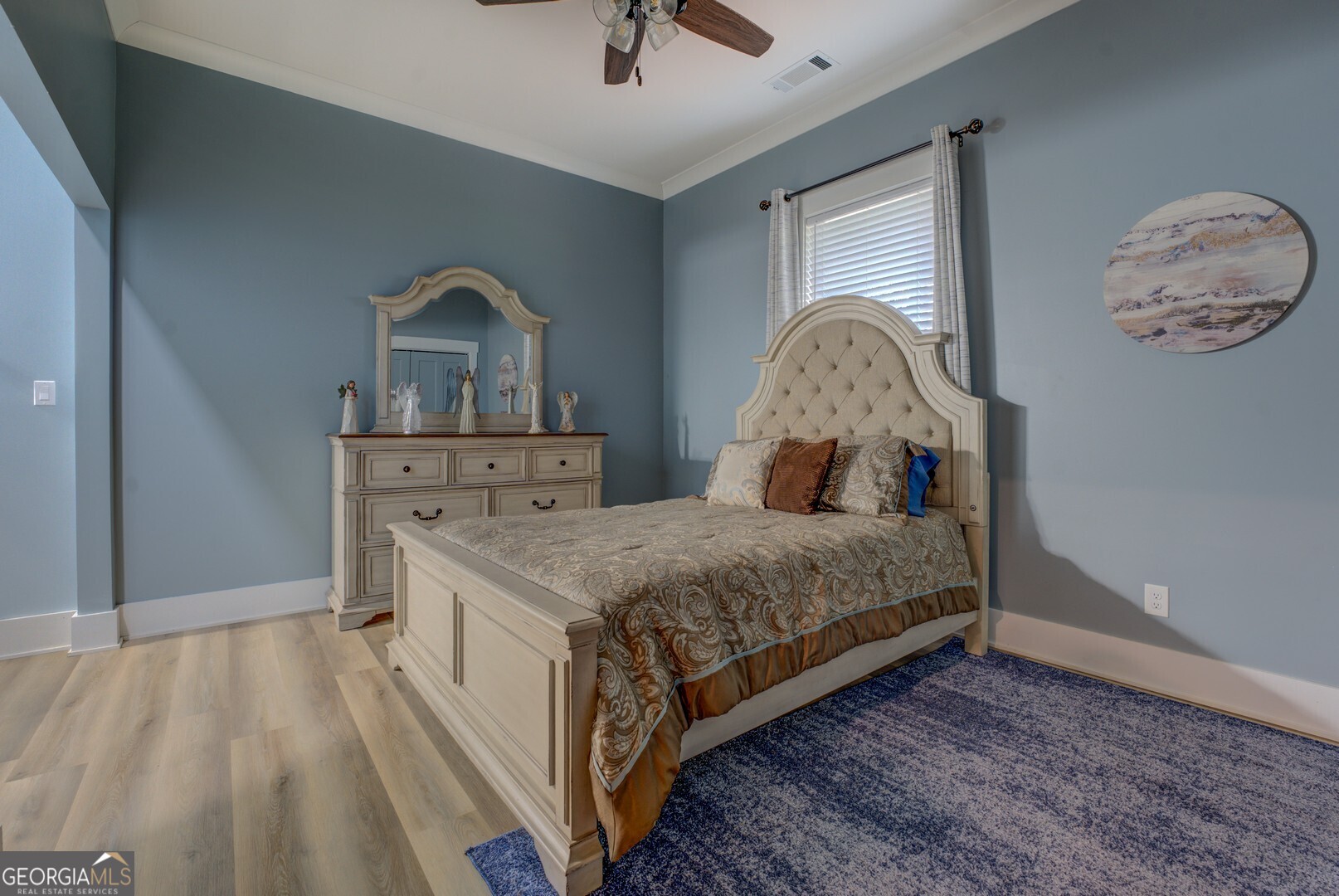 70 McDonald Road Covington, GA 30014 - Photo 48 of 84 a spacious bedroom with a bed and a chandelier