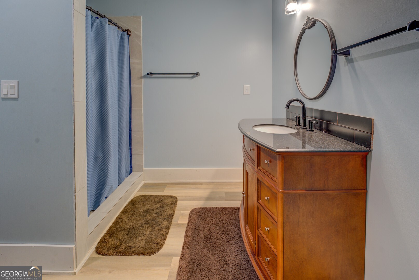 70 McDonald Road Covington, GA 30014 - Photo 50 of 84 a bathroom with a granite countertop sink and a mirror