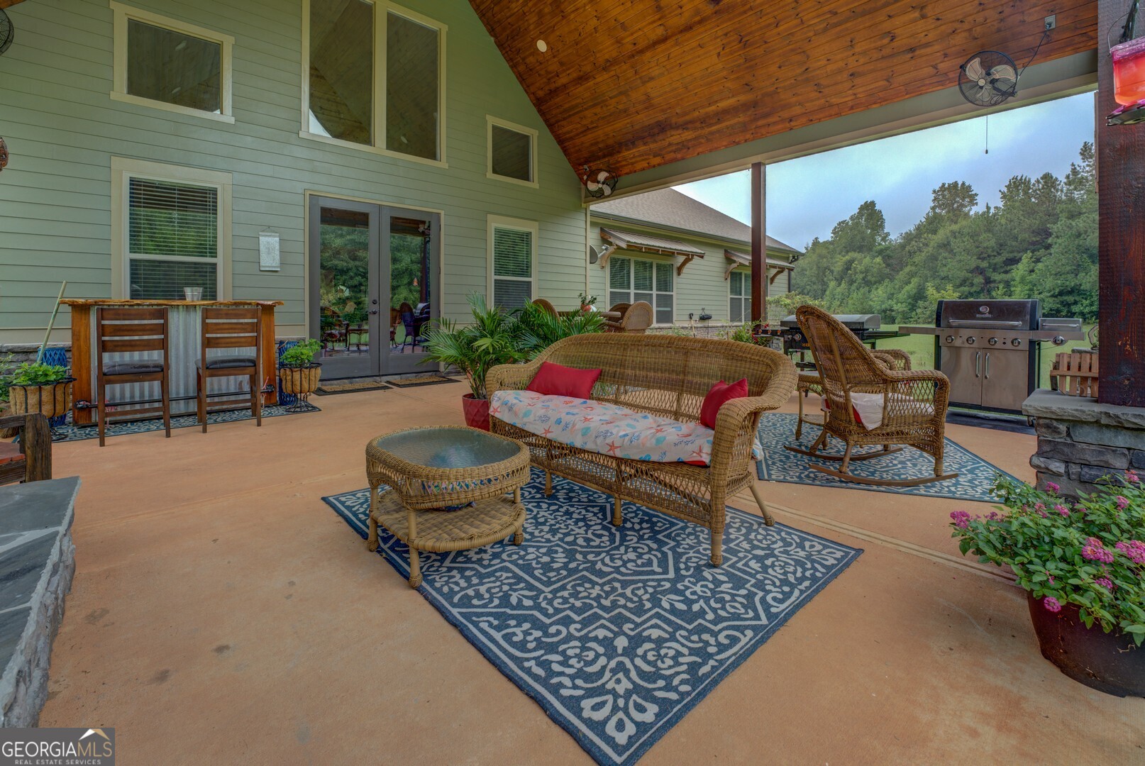 70 McDonald Road Covington, GA 30014 - Photo 74 of 84 a backyard of a house with barbeque oven table and chairs