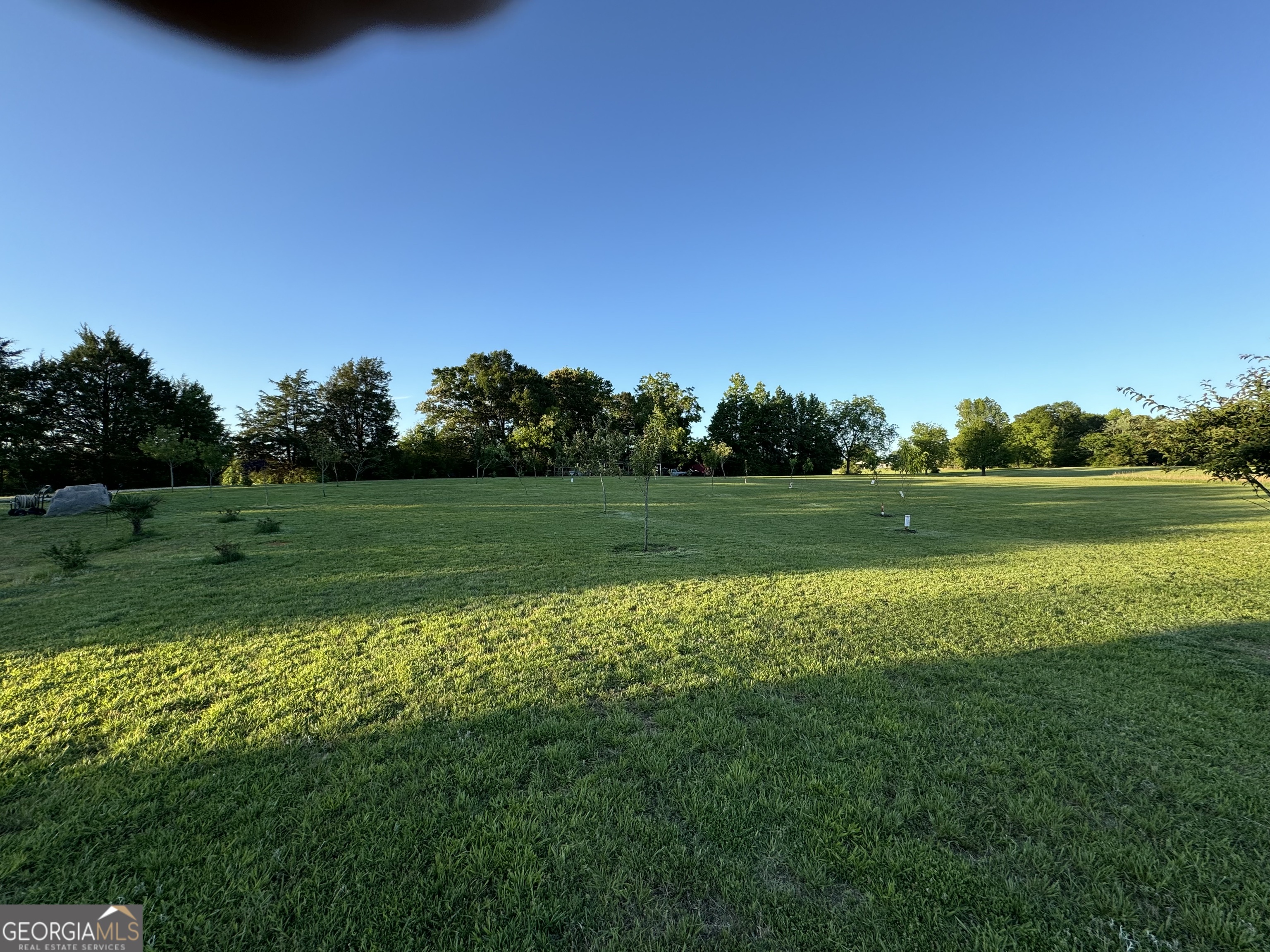 70 McDonald Road Covington, GA 30014 - Photo 75 of 84 a view of a golf course with a lake