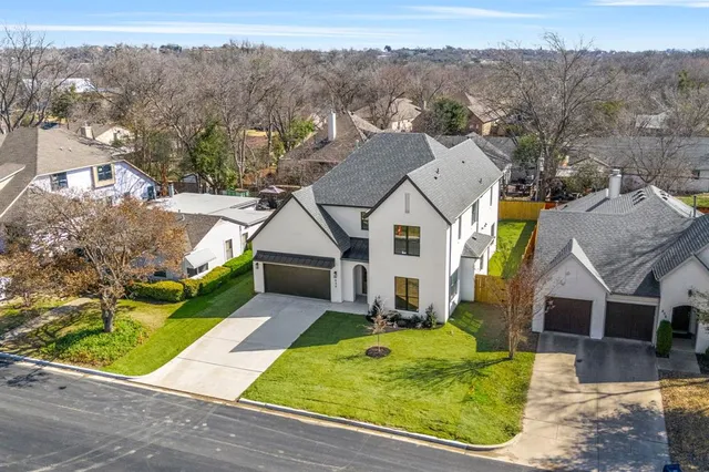 an aerial view of a house with a yard