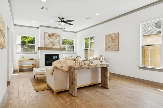a living room with furniture a fireplace and a table