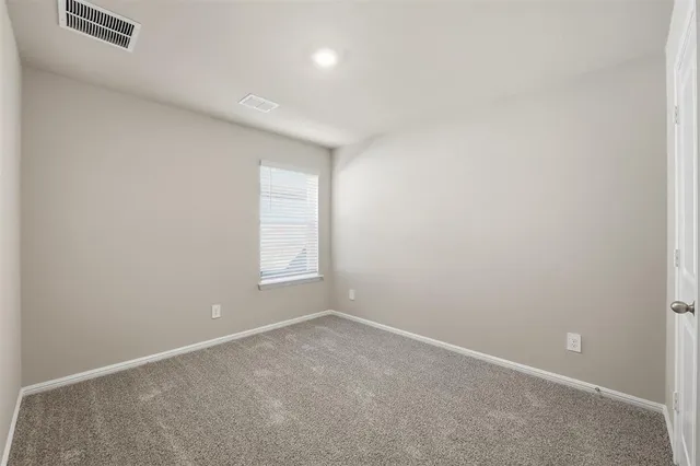 an empty room with a empty space and window