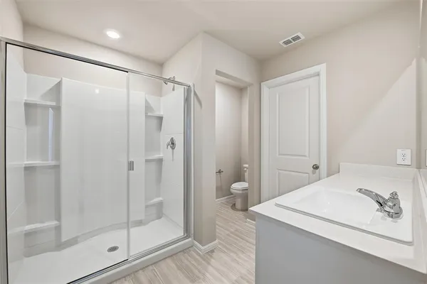 a bathroom with a granite countertop sink a shower and a mirror