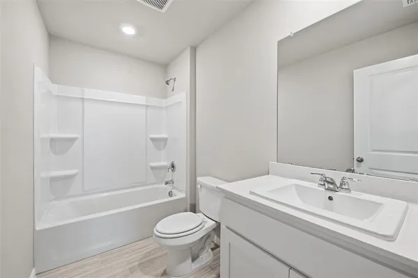 a bathroom with a sink toilet a mirror and shower