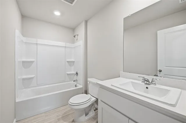 a bathroom with a sink toilet a mirror and shower