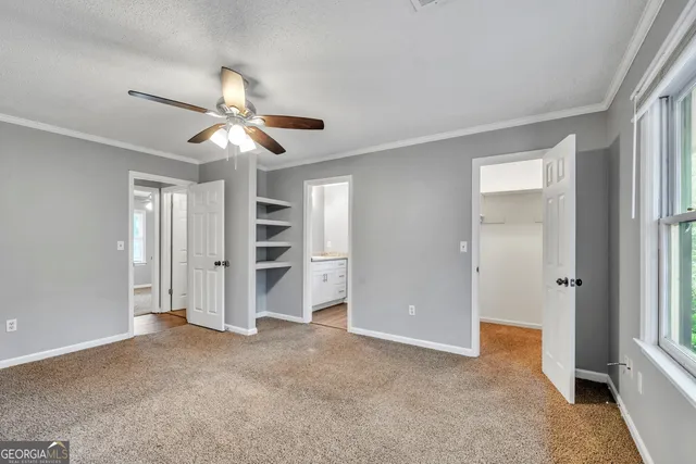 a view of empty room with closet and ceiling fan