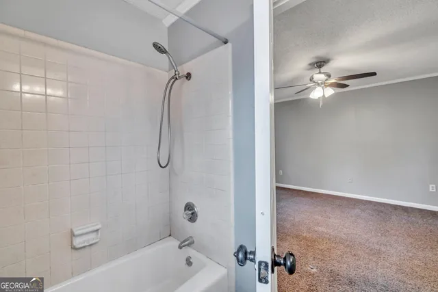 a bathroom with a shower a mirror and a shower