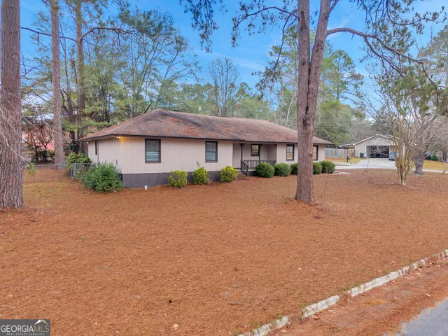 a view of outdoor space with garden and trees