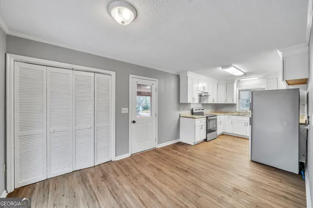 a kitchen with stainless steel appliances granite countertop a refrigerator and a sink
