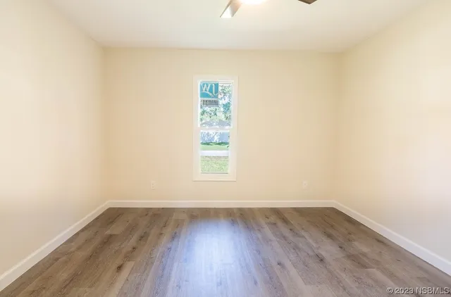 a view of a room with wooden floor and window