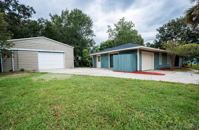 a house with green field in front of it